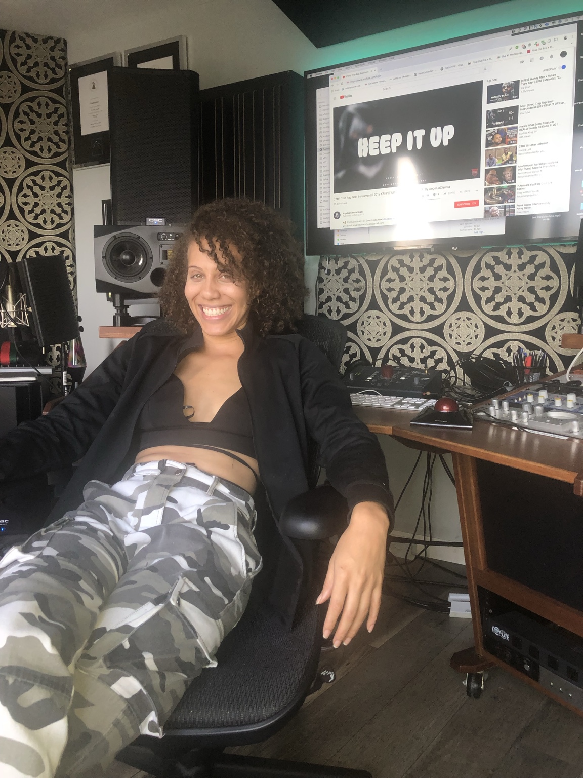 IREIGN smiling in a recording studio chair beside the mixing desk