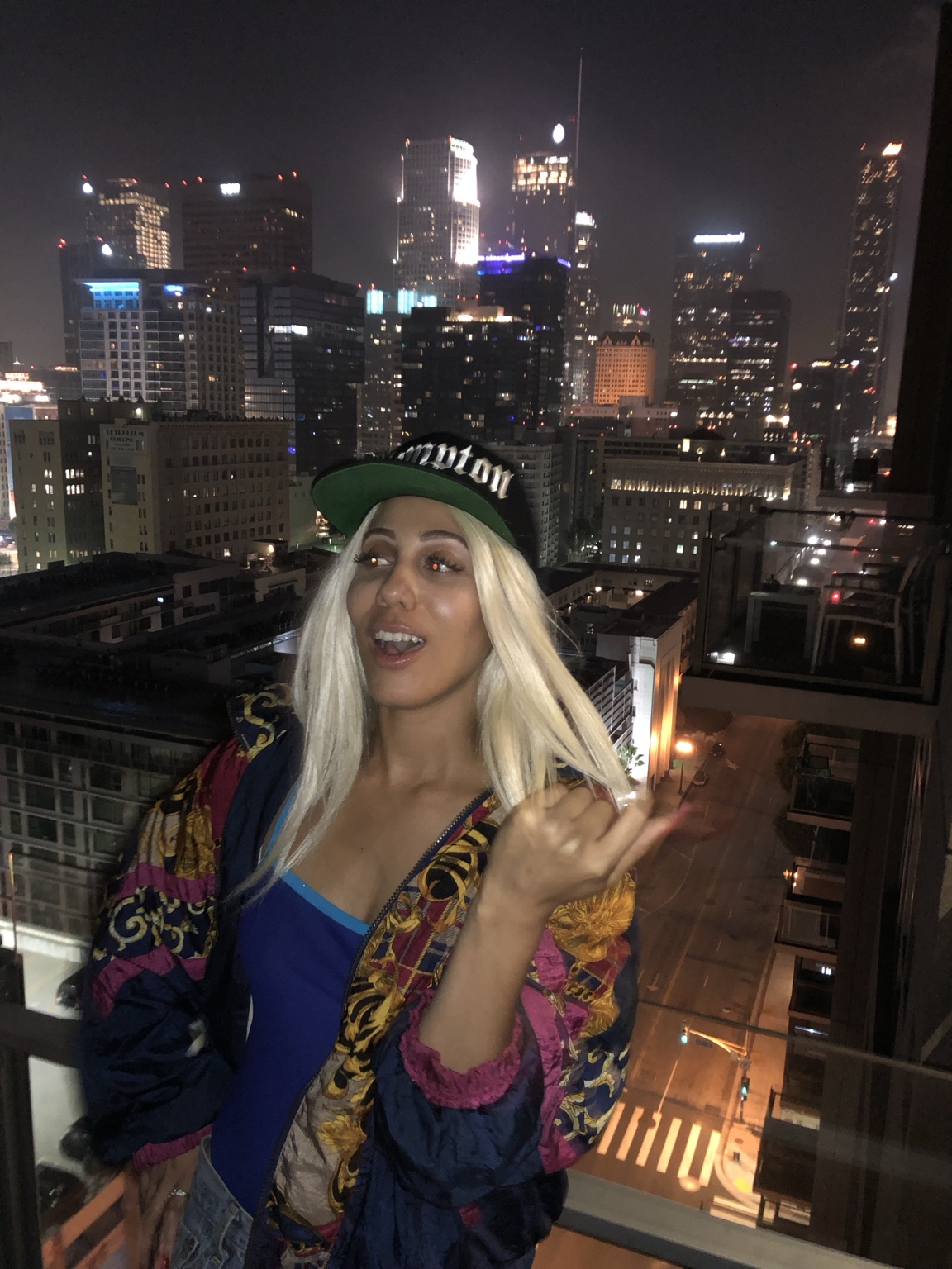 IREIGN on a rooftop at night with the Los Angeles skyline behind her